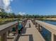 Scenic community pier overlooking a tranquil lake, offering a peaceful space for relaxation and reflection at 673 Crane Prairie Way, Osprey, FL 34229