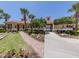 Beautiful community center with a terracotta tile roof, well-manicured landscaping, and gated entry at 673 Crane Prairie Way, Osprey, FL 34229