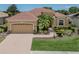 Charming home with a well-manicured lawn, brick driveway, and a two-car garage at 673 Crane Prairie Way, Osprey, FL 34229