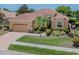 Inviting home exterior with brick driveway, lush landscaping, and a well-maintained lawn at 673 Crane Prairie Way, Osprey, FL 34229
