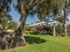 Lush garden with vibrant flowers and a pergola, offering a serene and beautiful outdoor space at 673 Crane Prairie Way, Osprey, FL 34229