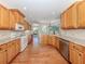 Kitchen with wood cabinets, stainless steel appliances, hardwood floors and granite countertops at 673 Crane Prairie Way, Osprey, FL 34229