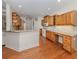 Kitchen with wooden cabinetry, granite countertops, hardwood floors, and open layout at 673 Crane Prairie Way, Osprey, FL 34229