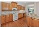Kitchen features wood cabinetry, granite countertops, stainless steel appliances and hardwood floors at 673 Crane Prairie Way, Osprey, FL 34229