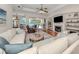 Comfortable living room featuring neutral tones, a fireplace, and a view of the outdoor pool at 673 Crane Prairie Way, Osprey, FL 34229