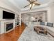 Bright living room featuring hardwood floors, fireplace, built-in shelving and decorative ceiling at 673 Crane Prairie Way, Osprey, FL 34229