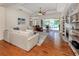 Bright living room featuring hardwood floors, a fireplace, and sliding doors to the outdoor pool area at 673 Crane Prairie Way, Osprey, FL 34229