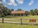 Legacy Trail picnic area featuring a covered pavilion, picnic tables, and a grassy field surrounded by trees at 673 Crane Prairie Way, Osprey, FL 34229