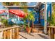 Quaint outdoor restaurant with red umbrella, surrounded by lush greenery and tropical charm at 673 Crane Prairie Way, Osprey, FL 34229