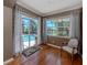 Bright sun room featuring a view of the pool and a comfortable chair at 673 Crane Prairie Way, Osprey, FL 34229