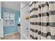 Bathroom with a shower-tub combo, shutters, and neutral colored accents at 6731 Washington Pl, Bradenton, FL 34207