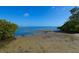 A serene beach with calm blue waters and lush greenery at 6731 Washington Pl, Bradenton, FL 34207