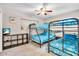 Bedroom featuring bunk beds, a ceiling fan and a console table with a TV at 6731 Washington Pl, Bradenton, FL 34207