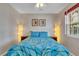 Inviting bedroom with wall art, bedside lamps, and window for natural light, providing a cozy retreat at 6731 Washington Pl, Bradenton, FL 34207