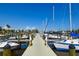 A view of the boat docks and boats at Bayshore Gardens Marina with a bright blue sky overhead at 6731 Washington Pl, Bradenton, FL 34207