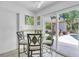 Breakfast nook with view to patio and pool through sliding glass doors at 6731 Washington Pl, Bradenton, FL 34207