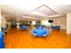 Spacious event hall with polished hardwood floors and elegant tables, ideal for celebrations and community gatherings at 6731 Washington Pl, Bradenton, FL 34207