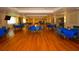 Large event hall with bright hardwood floors and numerous tables, suitable for community events and special occasions at 6731 Washington Pl, Bradenton, FL 34207