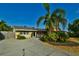 Charming single-story home with well-manicured landscaping and a sunny sky at 6731 Washington Pl, Bradenton, FL 34207