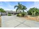 Charming single-story home with a spacious driveway, well-kept lawn, and beautiful palm trees at 6731 Washington Pl, Bradenton, FL 34207