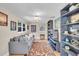 Cozy living room with wood floors, grey sofa, shelving, and natural light at 6731 Washington Pl, Bradenton, FL 34207