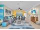 Inviting living room features two sofas, coastal decor, and a mounted television above wooden cabinet at 6731 Washington Pl, Bradenton, FL 34207