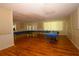 Bright meeting space with wood flooring and long tables, perfect for gatherings and events at 6731 Washington Pl, Bradenton, FL 34207