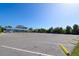 Vast parking area with ample space, located near a charming community building and surrounded by lush greenery at 6731 Washington Pl, Bradenton, FL 34207
