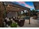 Outdoor pergola with cozy seating next to the pool and mature landscaping at 6731 Washington Pl, Bradenton, FL 34207