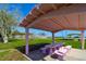 Pink painted picnic shelter with stone picnic table and green lawn in the background at 6731 Washington Pl, Bradenton, FL 34207
