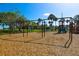 Community playground with swings and slides set on woodchips at 6731 Washington Pl, Bradenton, FL 34207