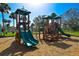 A colorful playground with slides and climbing structures under a bright blue sky at 6731 Washington Pl, Bradenton, FL 34207