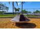 A spinning playground ride surrounded by wood chips at 6731 Washington Pl, Bradenton, FL 34207
