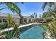 Backyard pool surrounded by lush landscaping, including a hot tub and pergola at 6731 Washington Pl, Bradenton, FL 34207