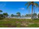 Outdoor pool with fence and palm trees on a clear day at the property at 6731 Washington Pl, Bradenton, FL 34207