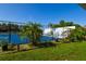 Well-maintained tennis court with a vibrant blue surface, surrounded by lush landscaping, providing a scenic backdrop for play at 6731 Washington Pl, Bradenton, FL 34207