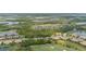 Community aerial view showcasing lush landscaping, golf course, waterways, and diverse housing options at 7005 River Hammock Dr # 303, Bradenton, FL 34212