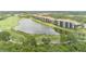 Beautiful aerial view of condominiums overlooking a golf course and lake, offering serene waterfront and golf views at 7005 River Hammock Dr # 303, Bradenton, FL 34212
