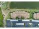 Aerial view of a well-maintained condo building with meticulously landscaped grounds and ample parking at 7005 River Hammock Dr # 303, Bradenton, FL 34212