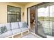 Relaxing balcony with comfortable seating and sliding door into the unit at 7005 River Hammock Dr # 303, Bradenton, FL 34212