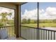 Relaxing view from screened balcony overlooking lush greenery and water at 7005 River Hammock Dr # 303, Bradenton, FL 34212