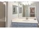 Bathroom with neutral countertops, blue vanity, decorative nautical accents, and glass shower at 7005 River Hammock Dr # 303, Bradenton, FL 34212