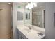 Bathroom featuring neutral countertops, framed mirror, glass shower, and nautical accents at 7005 River Hammock Dr # 303, Bradenton, FL 34212
