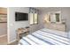 Bedroom with TV, beach themed decorations, and dresser mirror at 7005 River Hammock Dr # 303, Bradenton, FL 34212