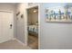 Bedroom view from hallway, with beach themed decorations and neutral wall colors at 7005 River Hammock Dr # 303, Bradenton, FL 34212