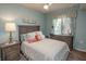 Well-lit bedroom with a comfortable bed, matching nightstands, and coastal-themed decorations at 7005 River Hammock Dr # 303, Bradenton, FL 34212