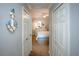 Hallway view into bedroom featuring coastal decor and carpet flooring at 7005 River Hammock Dr # 303, Bradenton, FL 34212