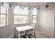 Bright breakfast nook with large windows, comfortable seating, and charming window treatments at 7005 River Hammock Dr # 303, Bradenton, FL 34212