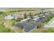 Exterior shot of condo buildings with parking, landscaping, and a glimpse of the golf course at 7005 River Hammock Dr # 303, Bradenton, FL 34212