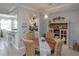 Dining room with a round wooden table, four wicker chairs, and a decorative hutch at 7005 River Hammock Dr # 303, Bradenton, FL 34212